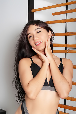 Nathaly Eagerly Teases Viewers With Her Curvaceous Figure And Playful Striptease Indoors