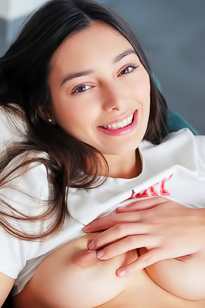 Shelena Lounges In Armchair, Embracing Sensual Charm With A Radiant Smile