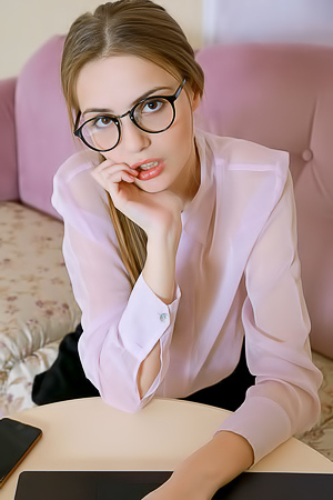 Elle Tan Puts Her Glasses Aside And Parts Her Slender Thighs So Her Short Skirt Rides Up